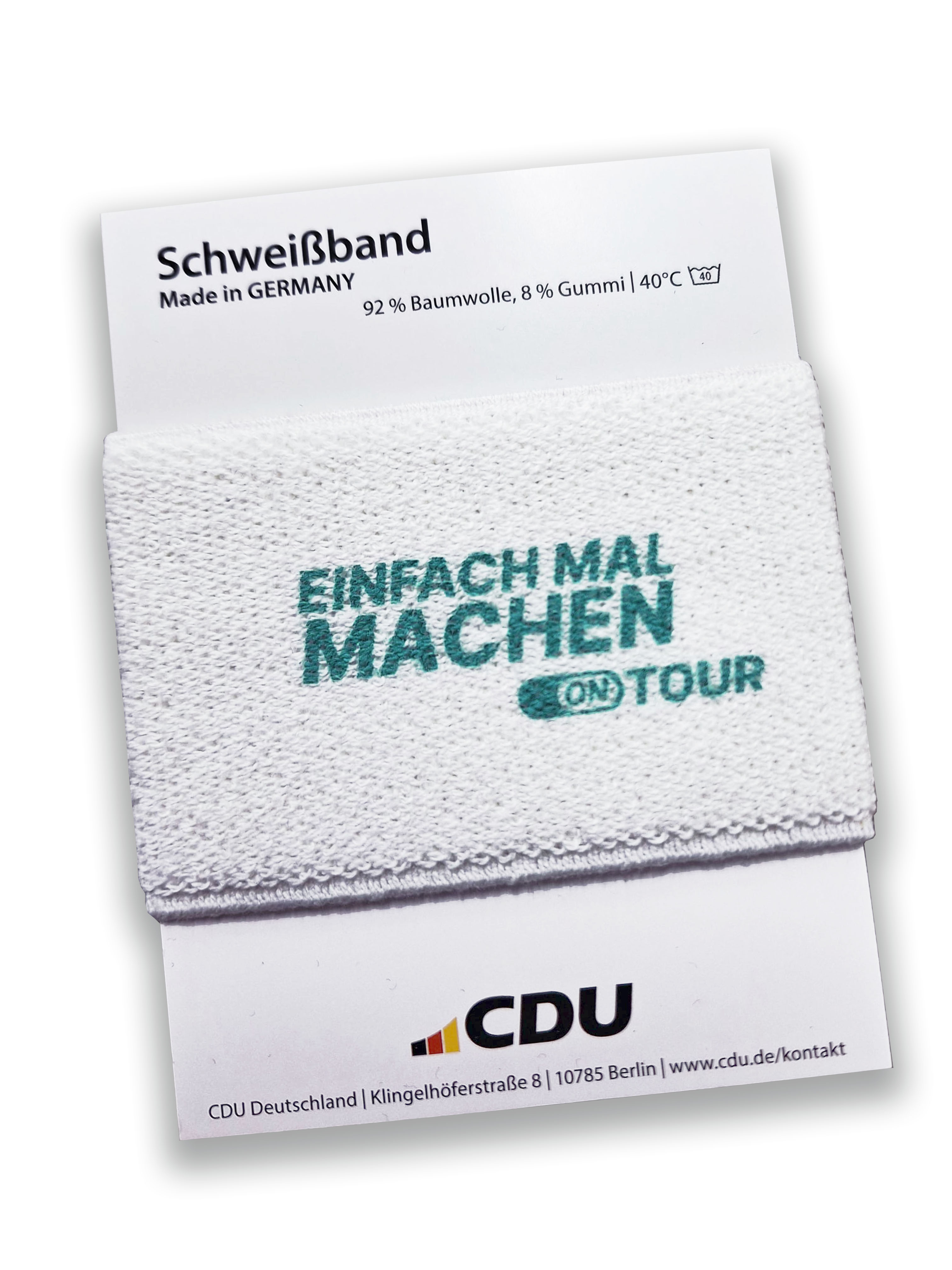 Schweißband in Weiß mit Aufdruck EMM-Logo in Türkis. Auf einer Trägerkarte aufgesteckt.